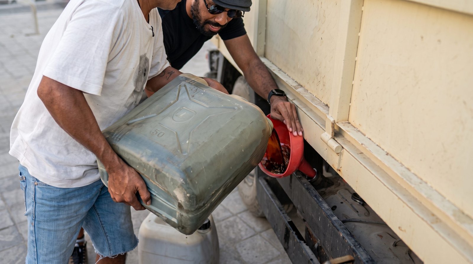 free diesel from plastic waste being poured into a Cepaka Village garbage truck